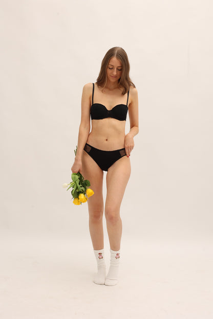 Full body front view of Cherrystain black lacey brief for light flow periods