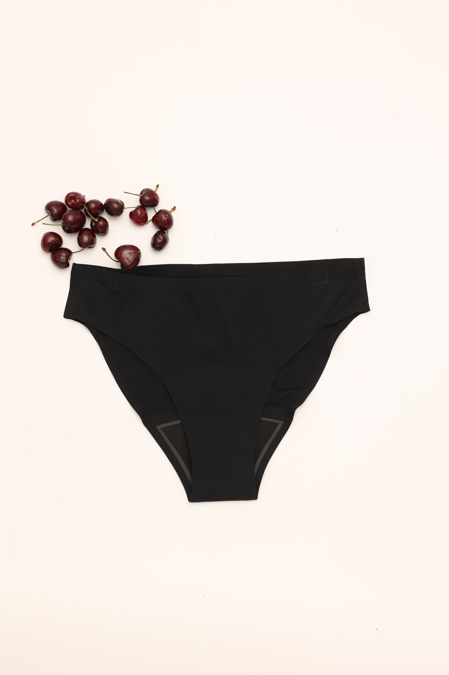 Flat lay of Cherrystain black seamless bikini medium flow period underwear
