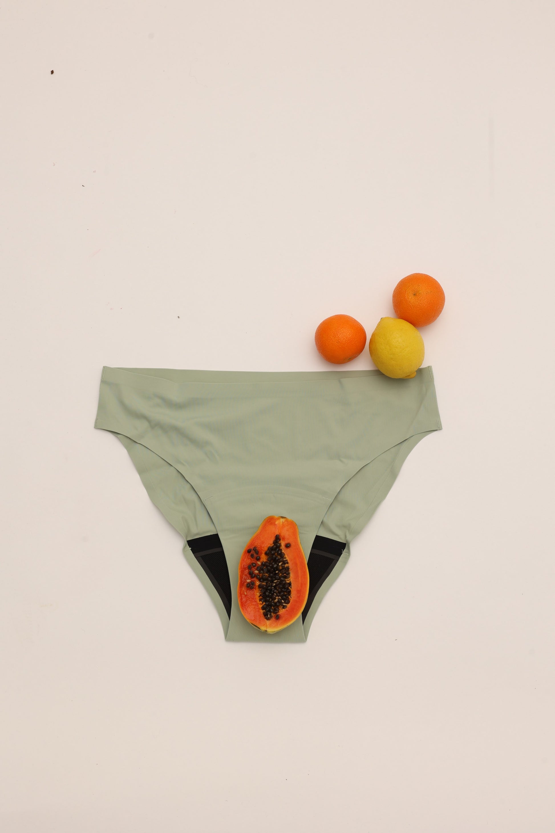 Flat lay of Cherrystain green seamless bikini medium flow period underwear