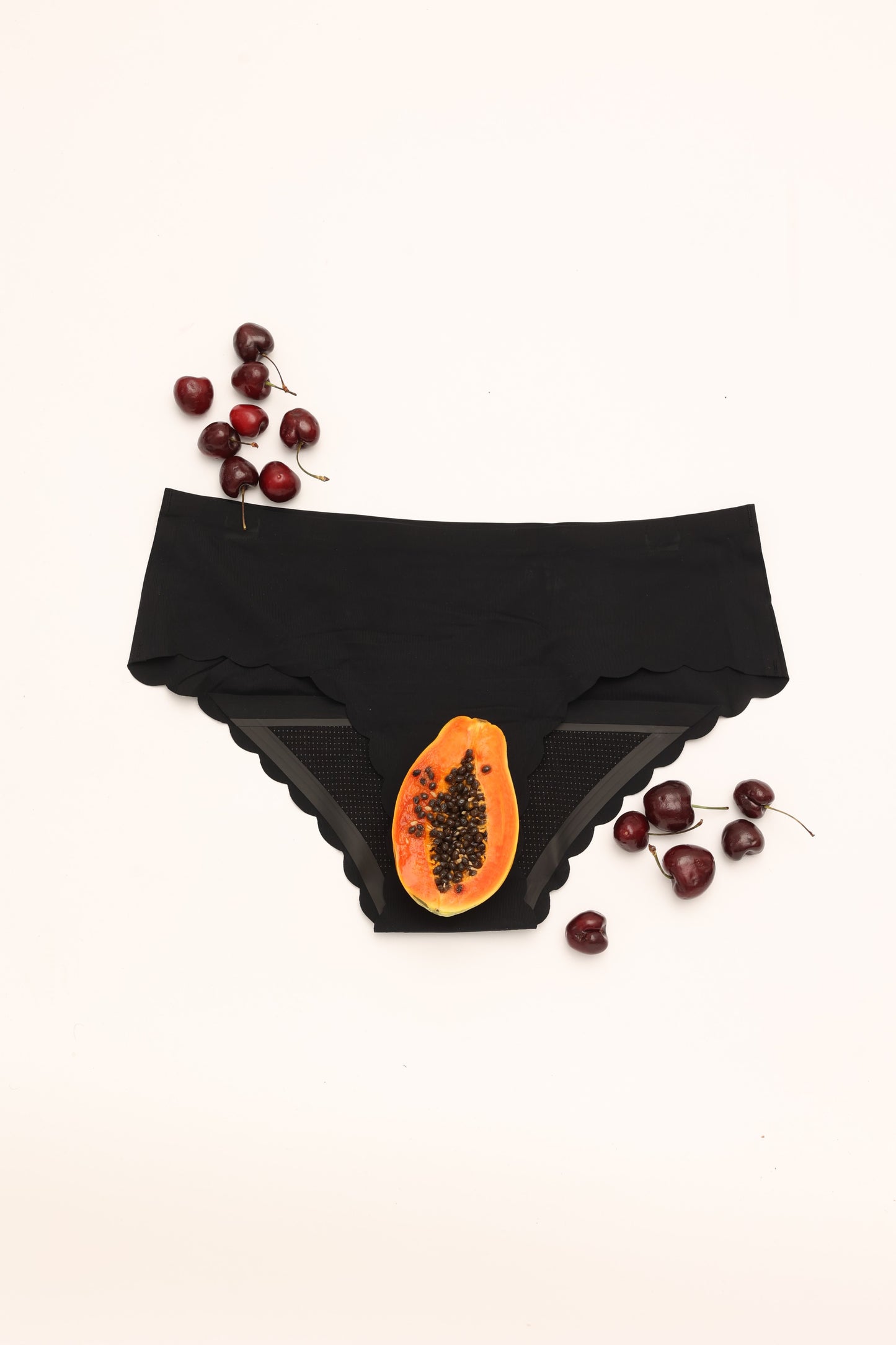Flat lay of Cherrystain black seamless brief medium flow period underwear