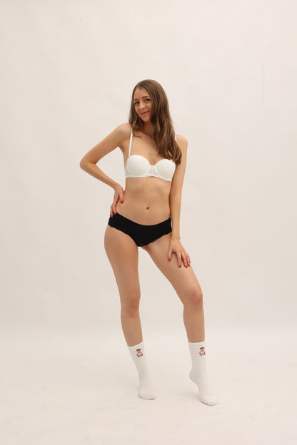 Full body front view of Cherrystain black seamless brief designed for medium flow periods
