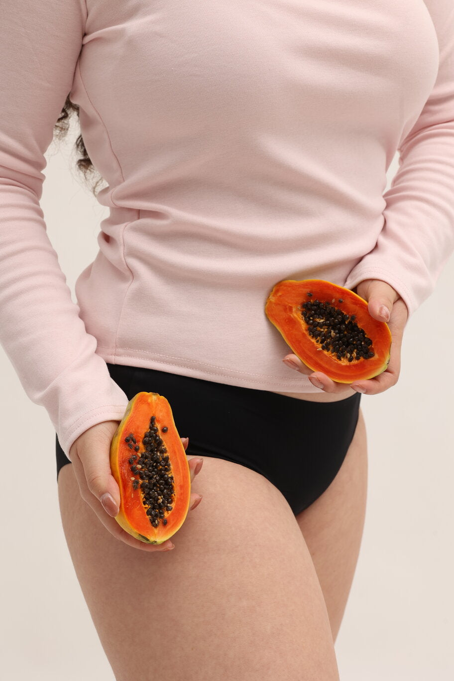 Model wearing seamless black menstrual underwear demonstrating smooth second skin fit under clothing